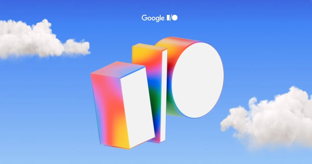 Google I/O logo as colorful 3D blocks forming the letters I and O against a blue sky with clouds.
